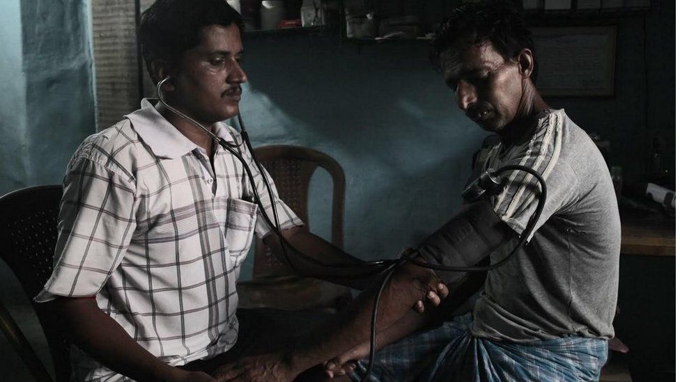 Sanjoy Mondal checking blood pressure level of a patient