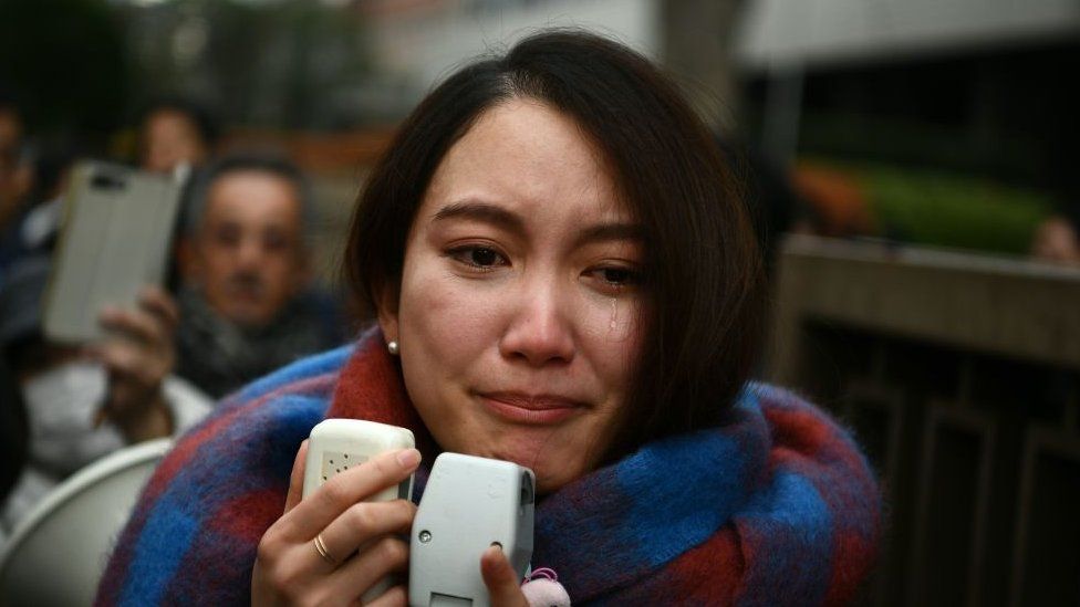 Japanese journalist Shiori Ito sheds a tear as she speaks to reporters outside the Tokyo district court