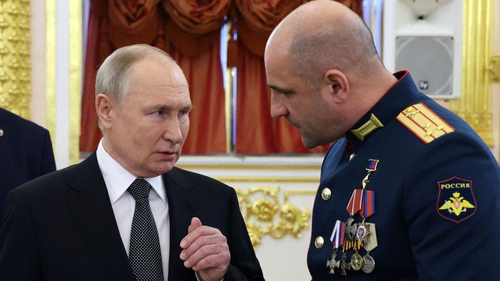 President Vladimir Putin speaking with Lieutenant Colonel Artyom Zhoga during a ceremony to present Gold Star medals to Heroes of Russia at the Grand Kremlin Palace in Moscow on December 8, 2023.