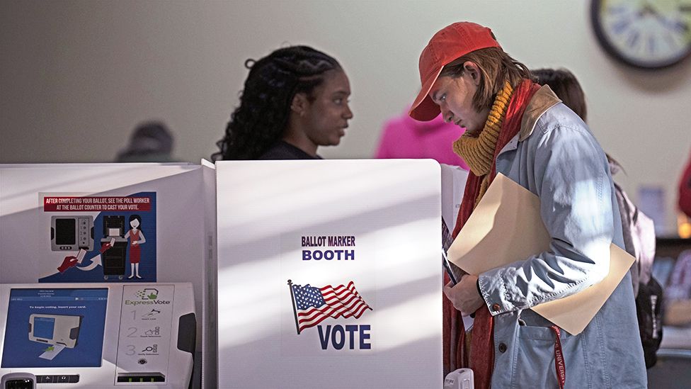 People vote at booths inside