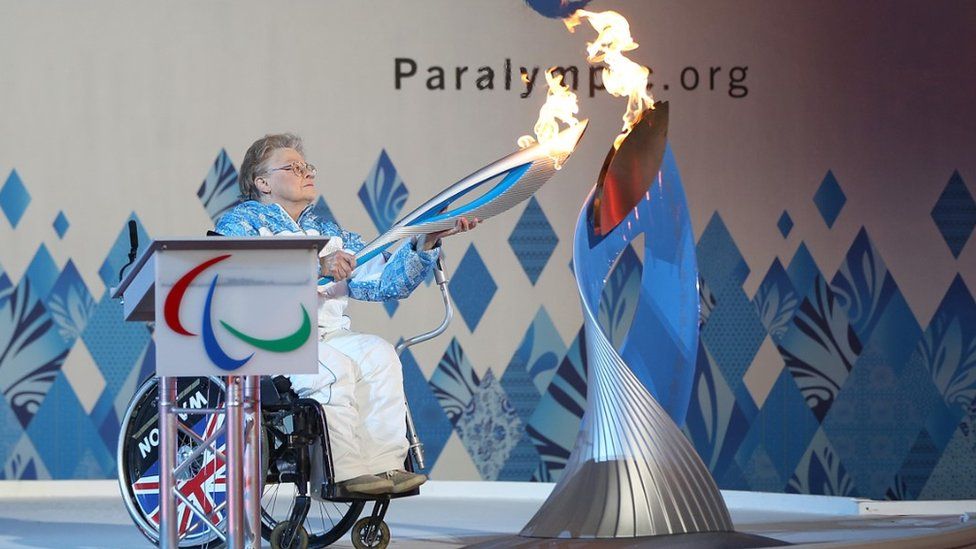 Caz Walton lights a torch at Stoke Mandeville to celebrate the Winter Paralympic Games in Sochi, 2014