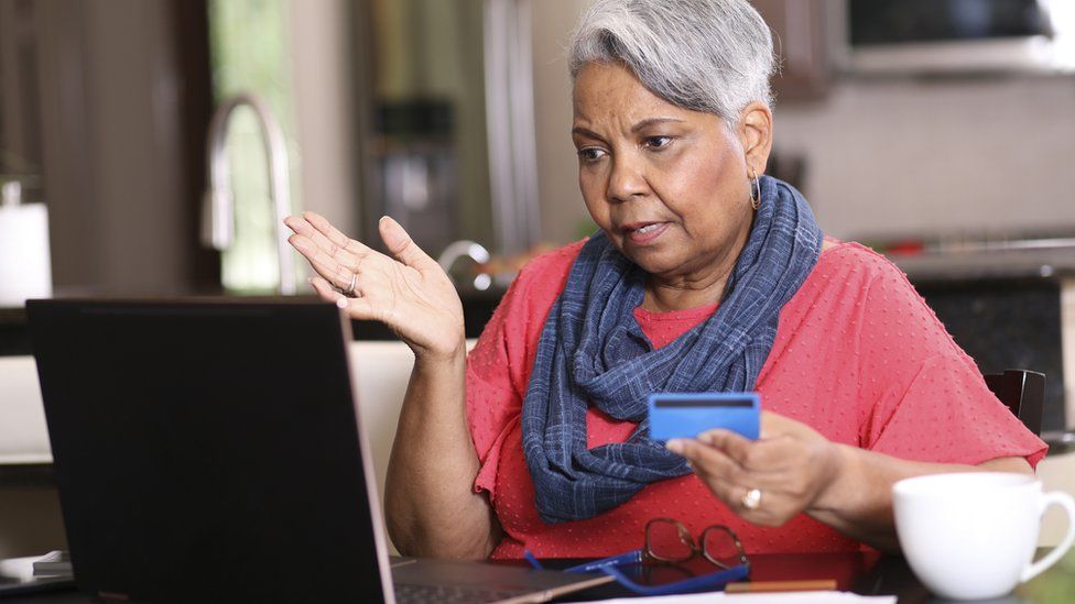 A stock image of an older woman at a computer