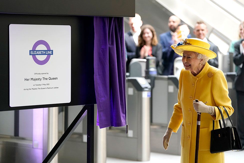 Queen Elizabeth II unveils a plaque to mark the Elizabeth line's official opening at Paddington Station in London