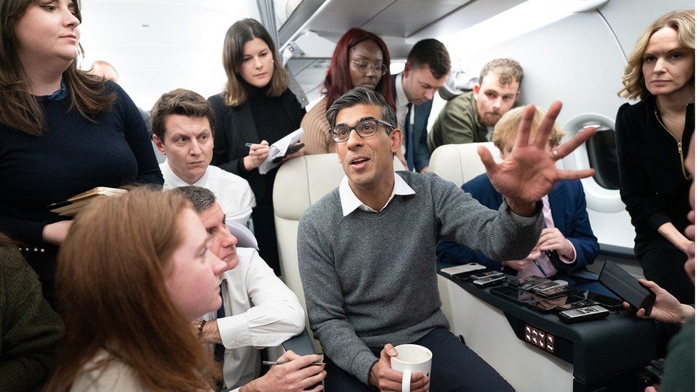 Rishi Sunak speaks to journalists on board a government plane to Dubai