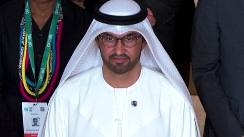 Sultan al-Jaber standing with delegates