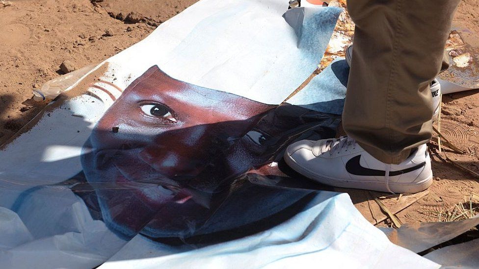 A poster of Yahya Jammeh underfoot after his election defeat