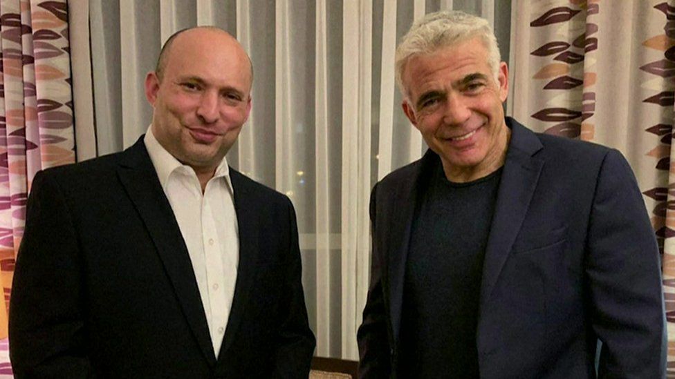 The right-wing Yamina party's Naftali Bennett and Yair Lapid, leader of the centrist Yesh Atid party, after reaching an agreement