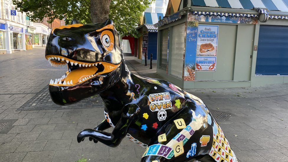 Game-themed dinosaur statue