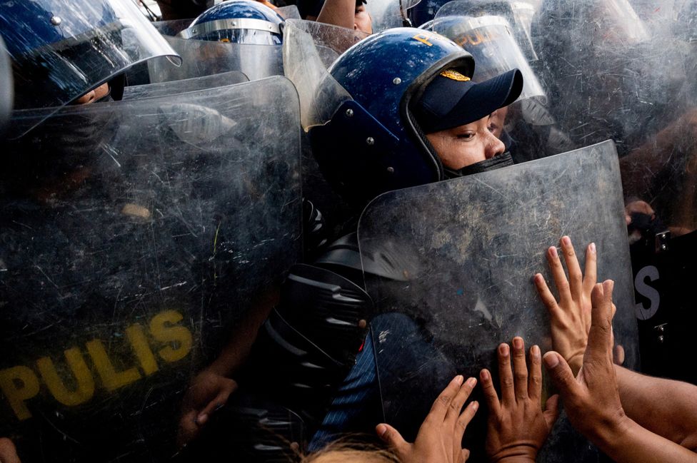 Police officers block activists during a protest denouncing the proclamation of the new Philippine president and vice president, in front of the Commission on Human Rights, in Quezon City, Metro Manila, Philippines, on 25 May 2022