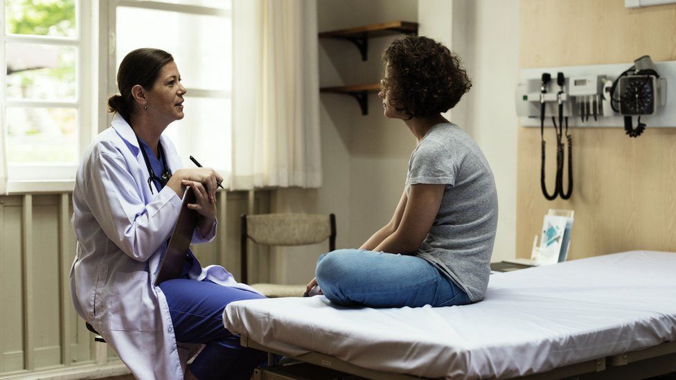 Woman being treated by a doctor