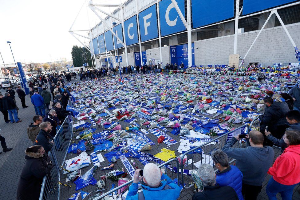 People look at tributes left outside Leicester City"s King Power stadium, on October 29th 2018
