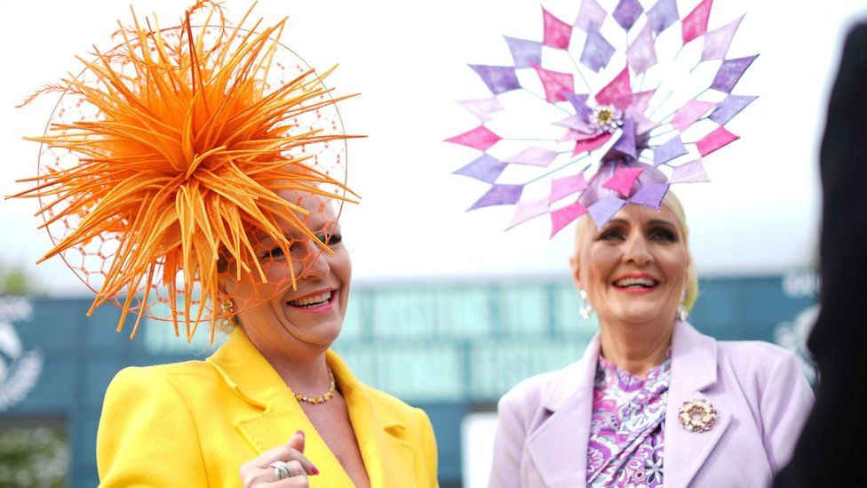 Two women wearing fascinators at Aintree Ladies Day 2024