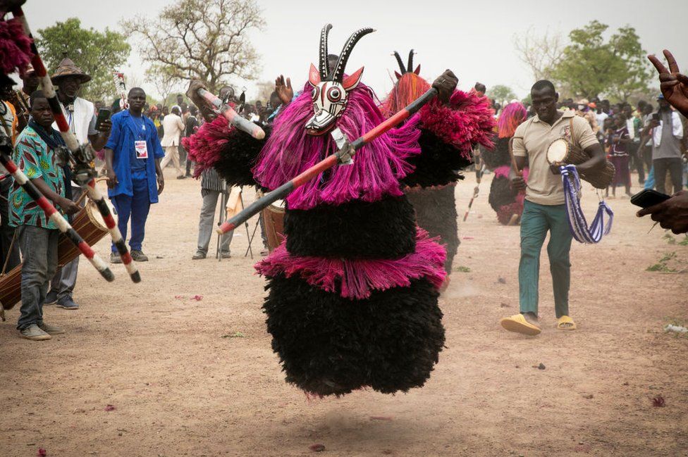 A person in a traditional mask representing a koba (antelope) dances during the Festimasq, the Festival des Masques in Pouni, Sanguie province, on March 30, 2024.