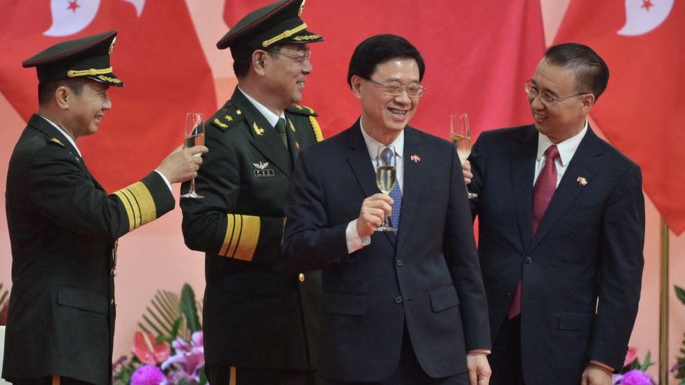 Acting Hong Kong Chief Executive John Lee (2nd R) toasts with Chinese officials following a flag-raising ceremony to mark the 24th anniversary of Hong Kong's handover from Britain in Hong Kong on July 1, 2021.