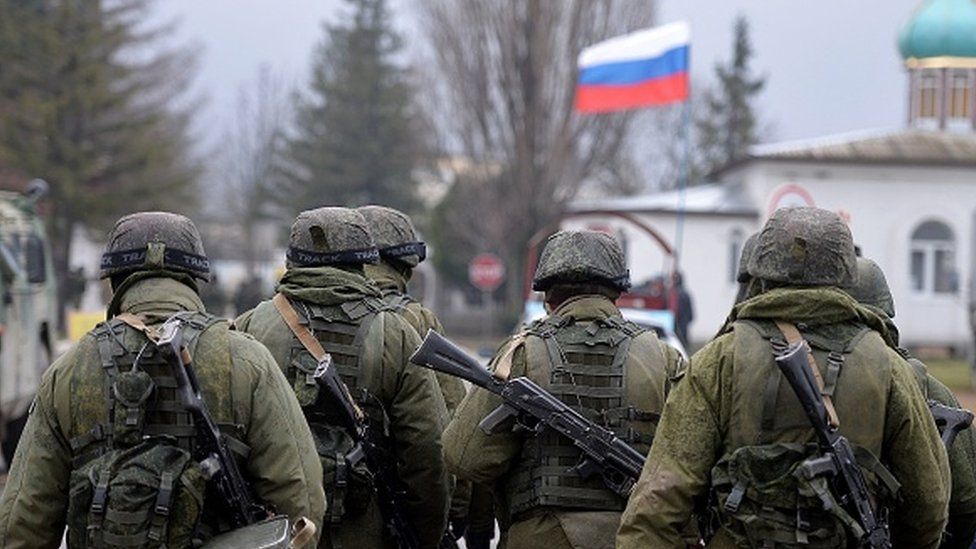 Russian soldiers patrol the area surrounding the Ukrainian military unit in Perevalnoye, outside Simferopol, in 2014