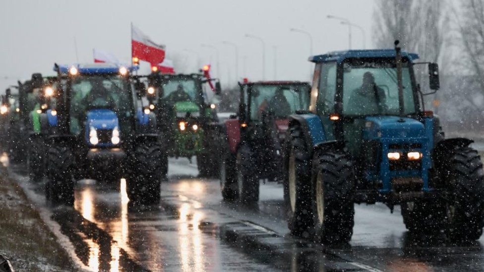 Polish farmers slow down traffic on a road with tractors during a protest over price pressures, taxes and green regulation, grievances shared by farmers across Europe, in Poznan, Poland