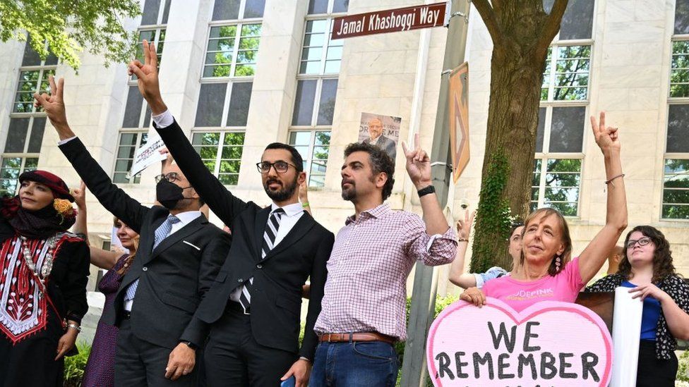 People stand outside embassy