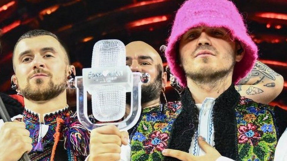 Members of the band Kalush Orchestra pose on stage with the winner's trophy and Ukraine's flags after winning on behalf of Ukraine the Eurovision Song contest 2022 on May 14, 2022 at the Pala Alpitour venue in Turin