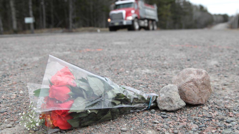 Flowers lay at a crime scene at the side of the Plains Road April 20, 2020 in Debert, Nova Scotia, Canada