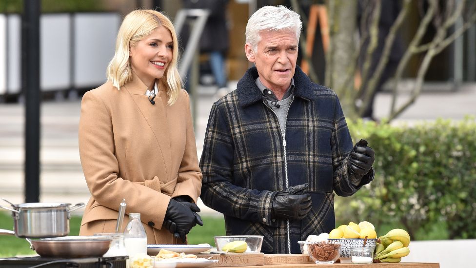 Holly Willoughby and Phillip Schofield with Ainsley Harriott attempt a world record for tossing pancakes during the This Morning show. on February 25, 2020 in London, England