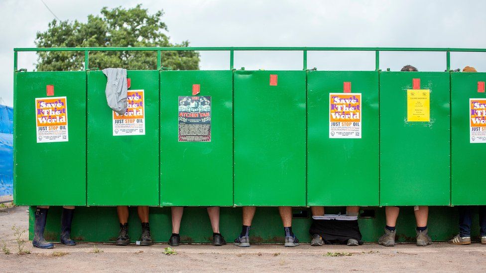Festivalgoers visiting the toilet on the third day of the Glastonbury Festival