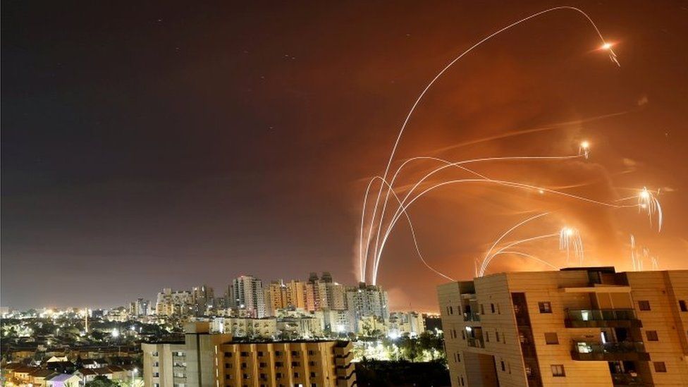 Streaks of light are seen as Israel's Iron Dome anti-missile system intercept rockets launched from the Gaza Strip, as seen from Ashkelon, Israel (12 May 2021)