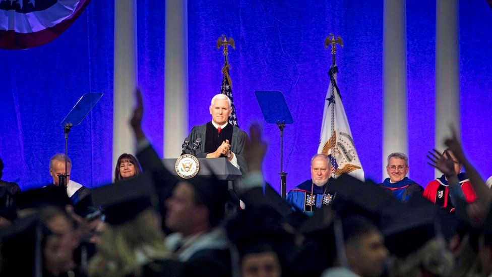 Mike Pence stands at the podium at Hillsdale College