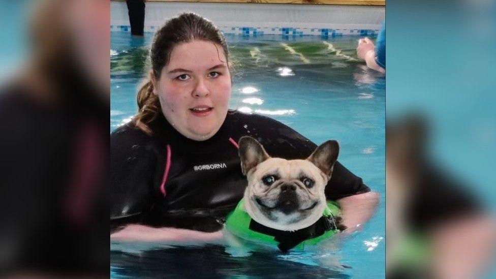 Abi Raffles and Coco the pug in swimming pool
