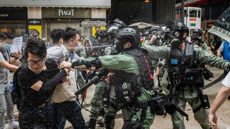 Riot police pepper spray while clashing with a group of mediators during demonstrations against the draft bill.