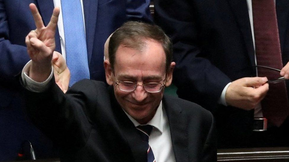 Mariusz Kaminski gestures during a parliamentary session in December 2023