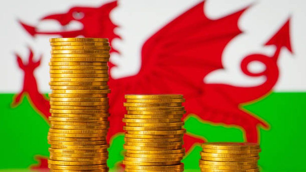 Stacks of coins on the background of Welsh flag