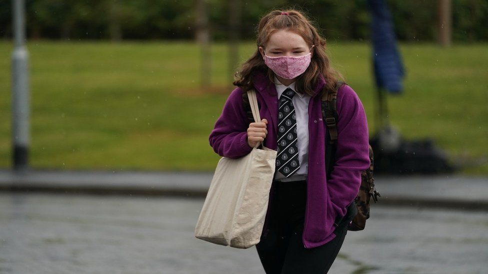 A schoolgirl wearing a mask