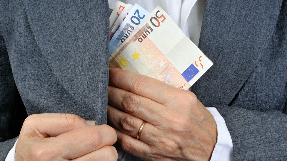 Man putting euros in pocket