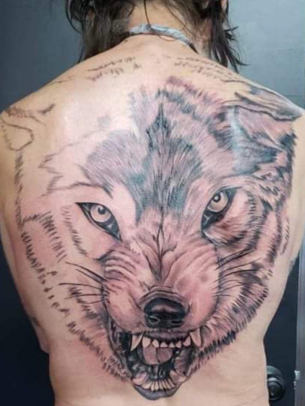 Avis sported a giant wolf tattoo across his back