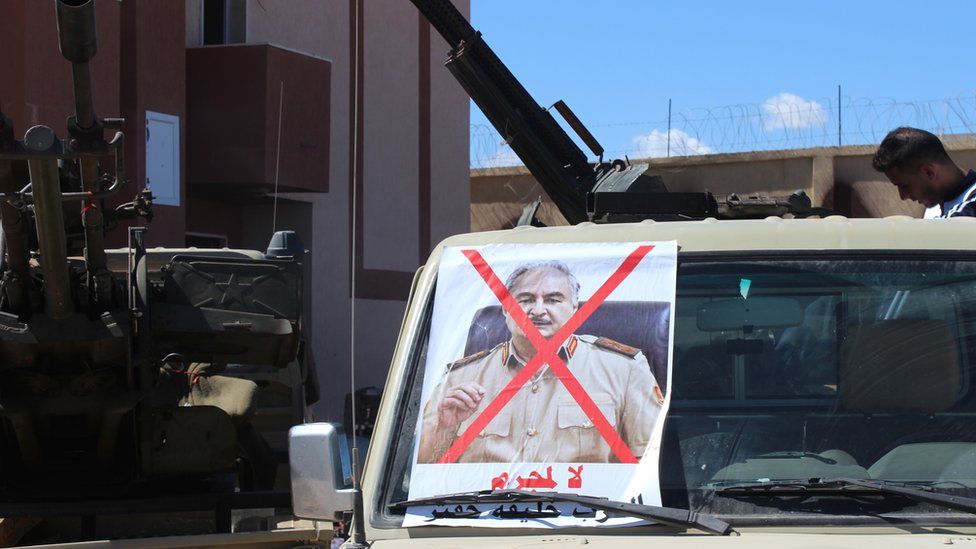 An photo of Gen Haftar with a cross through on a vehicle in Tripoli - April 2019