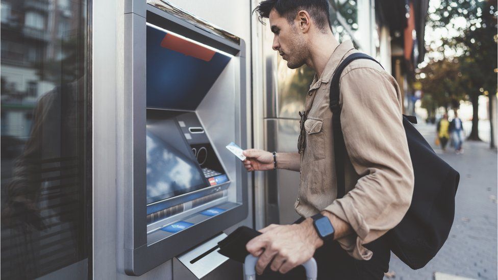 Man by cash machine
