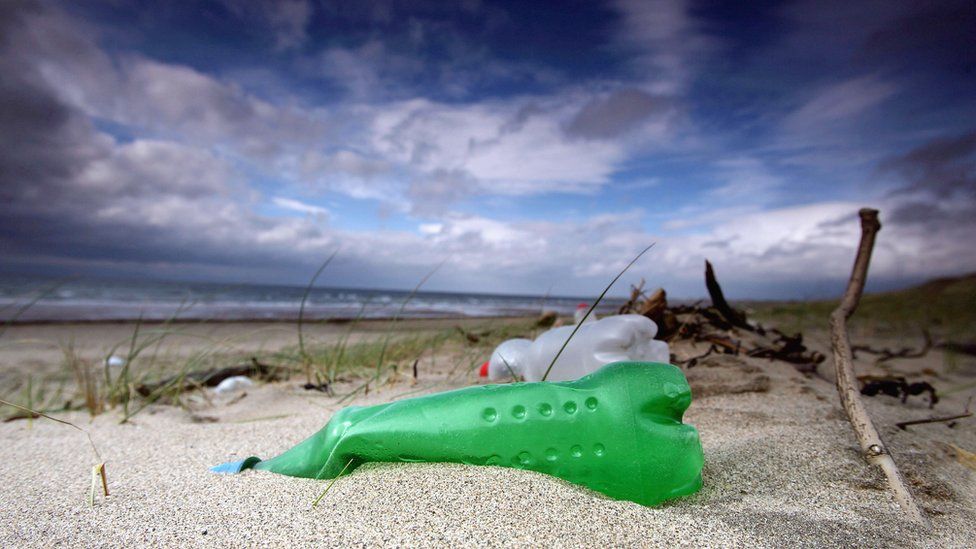 Plastic bottles in sand
