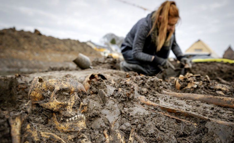 Archaeologists work at a mass grave on the city moat in Vianen, on November 24, 2020