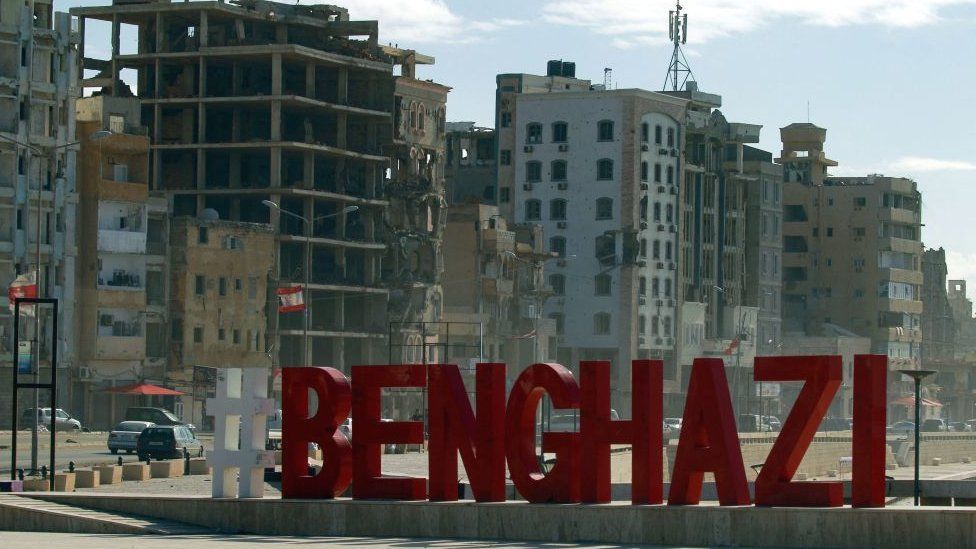A Benghazi sign is pictured in front of war-ravaged buildings in Benghazi, Libya - 15 October 2021