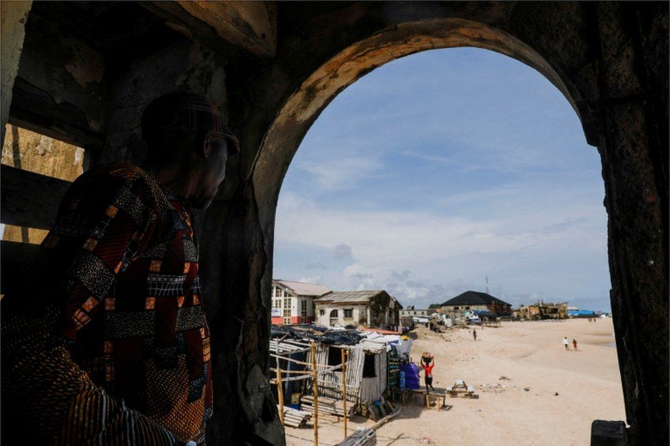 A man looks through a view at the Alpha beach, affected by an ocean surge, in Lagos, Nigeria on 21 June.