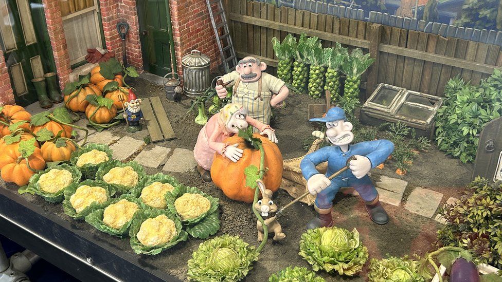 Puppets gardening in a Wallace & Gromit Scene