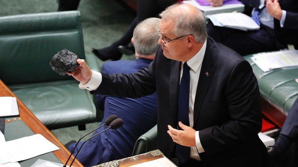 Prime Minister Scott Morrison holds a lump of coal while giving a speech in parliament.