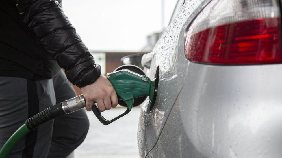 Driver filling up car with petrol