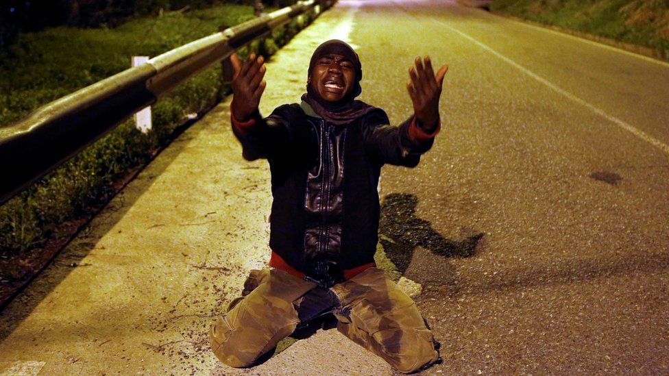 An African migrant reacts on a road after crossing the border fence between Morocco and Spain"s north African enclave of Ceuta, December 9, 2016