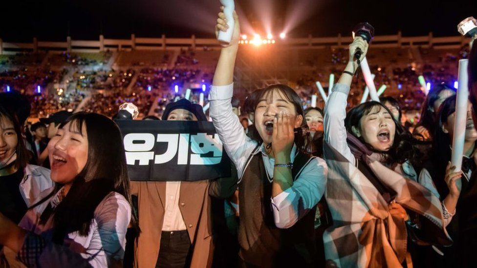 Fans cheer for their a professional K-pop band in Changwon, South Korea