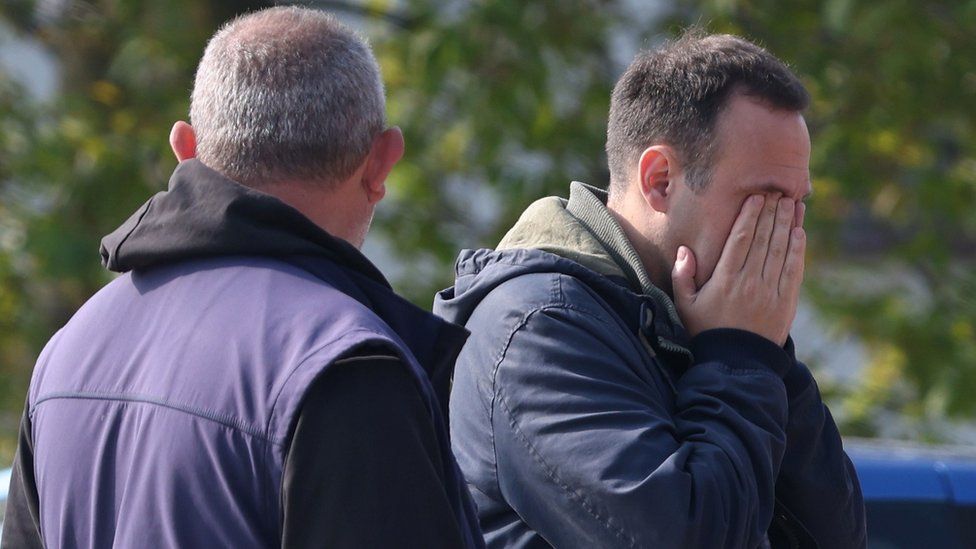 A man grieves in the village Dubona after the attack.