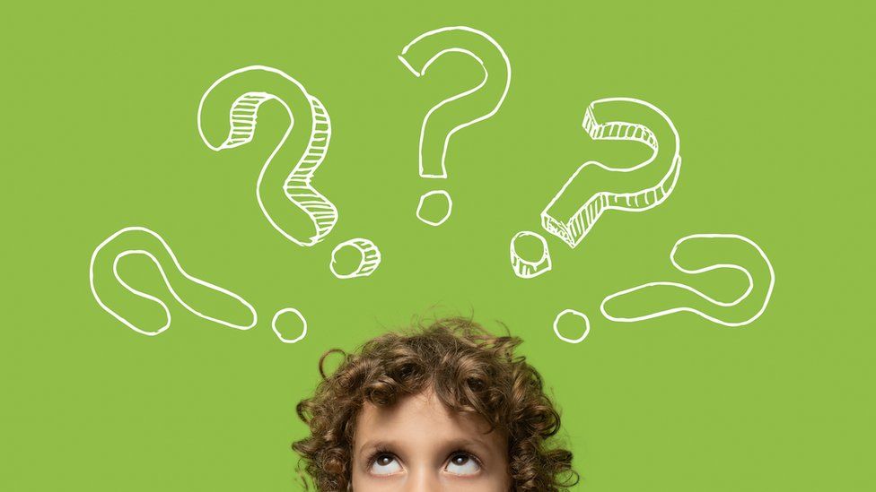 child thinking and looking up at drawn question marks