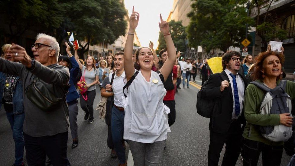 A woman dances during protests against university cuts in Buenos Aires.