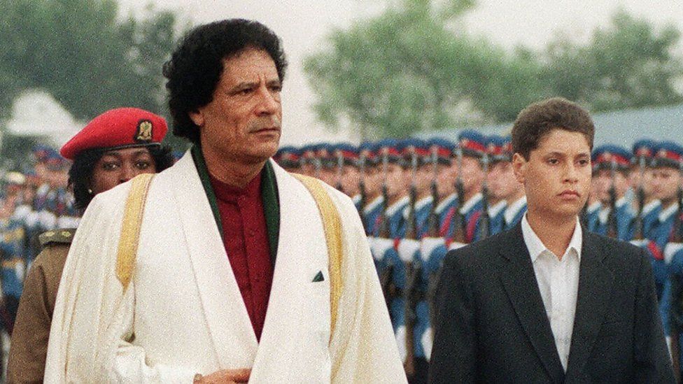 Muammar Gaddafi with Saif al-Islam, reviewing troops in 1989
