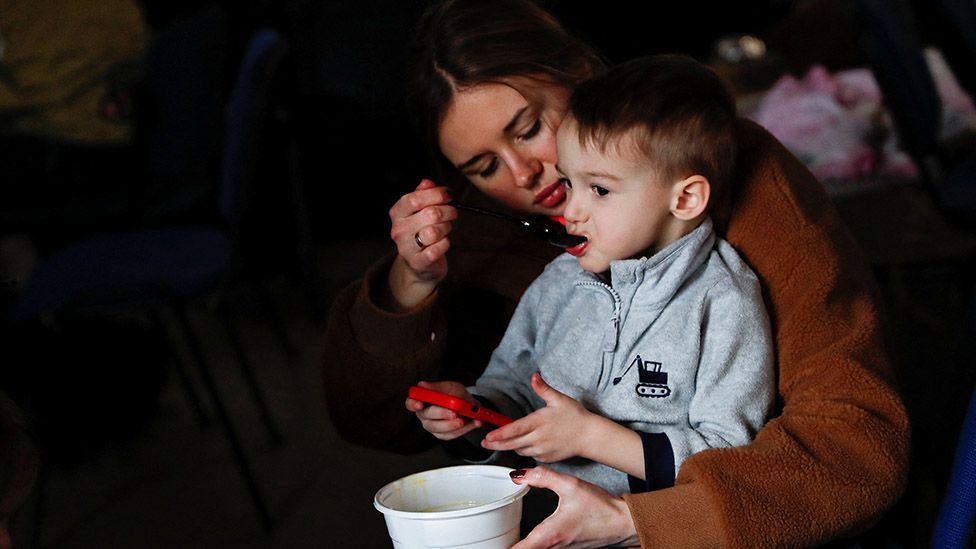 A mother feeds her child at a refugee shelter in Beregsurany, Hungary, 28 February 2022